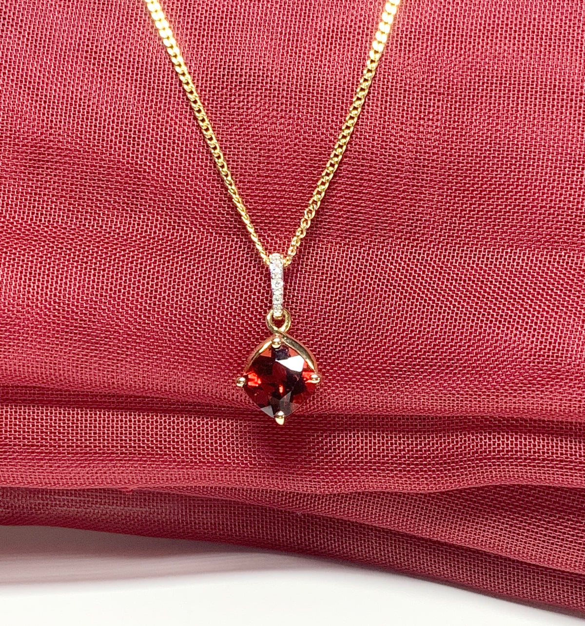 A red brown real garnet and diamond necklace yellow gold cushion shaped pendant