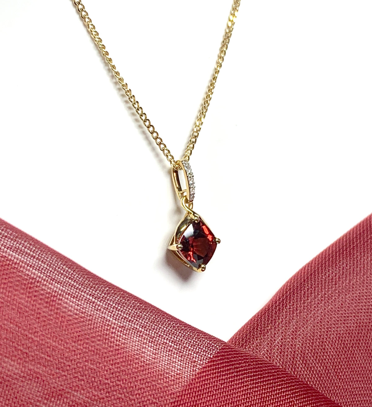 A red brown real garnet and diamond necklace yellow gold cushion shaped pendant