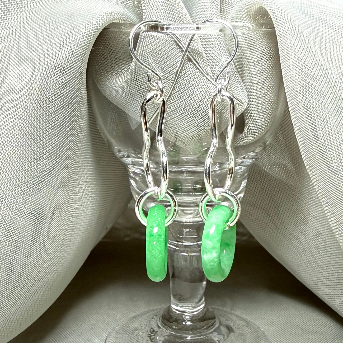 A rounded shaped real green jade sterling silver looped dangling dropped earrings
