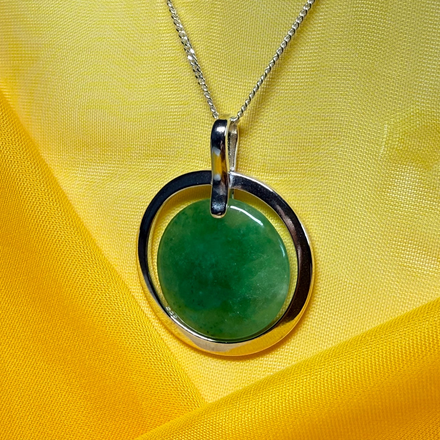 A shimmering large round halo necklace sterling silver circle shaped green real jade