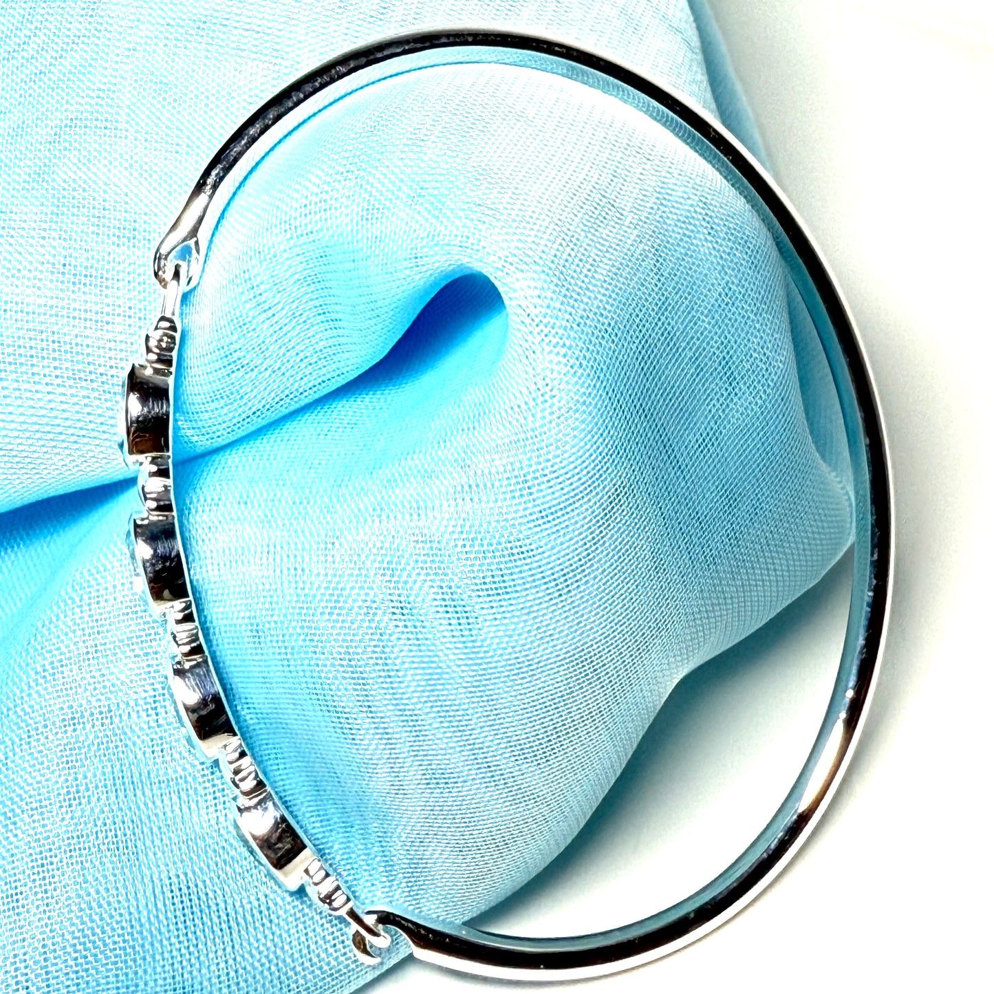 Sterling silver four oval blue topaz kiss bangle