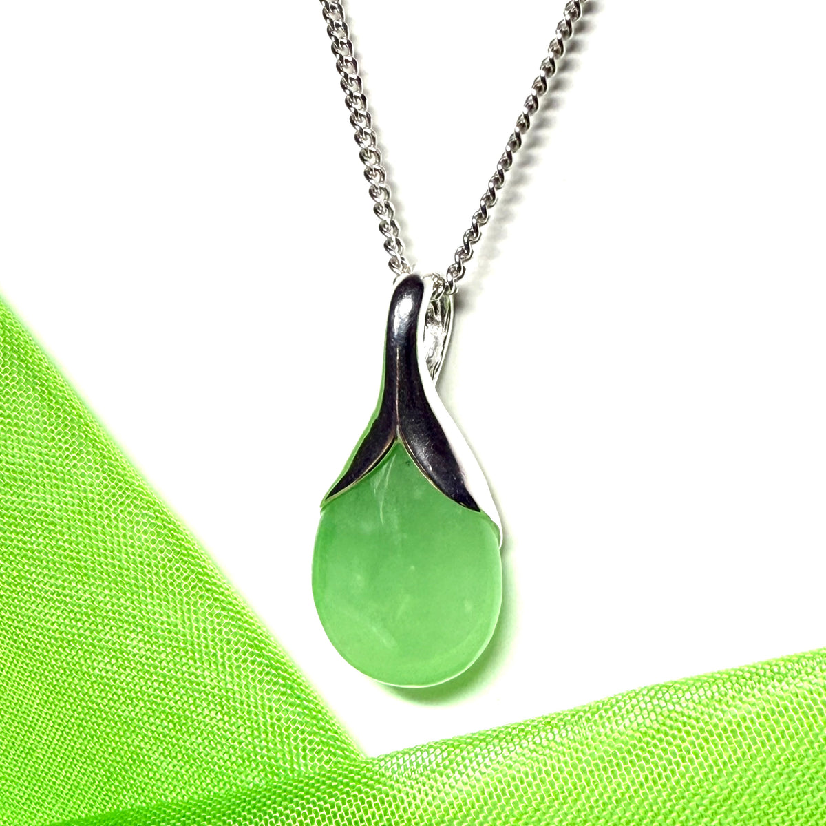 A stunning real green jade necklace in a teardrop or a pear shape including a solid curb chain