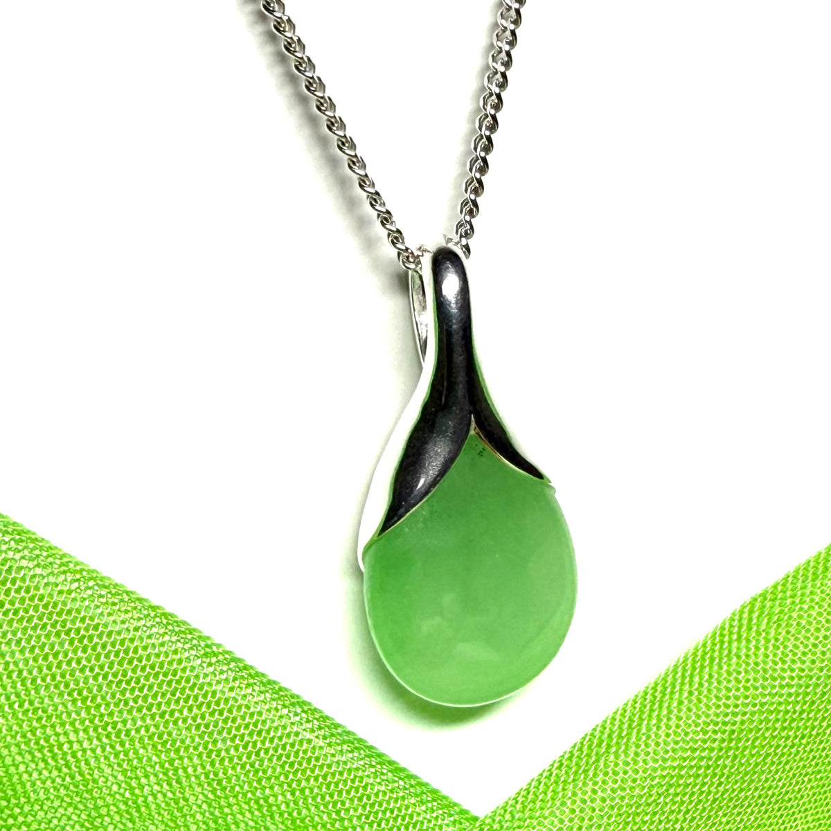 A stunning real green jade necklace in a teardrop or a pear shape including a solid curb chain