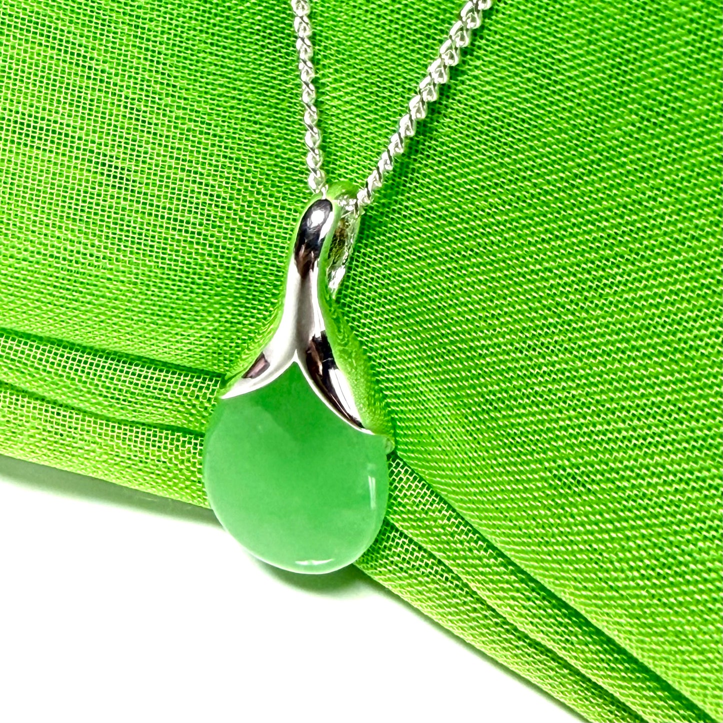 A stunning real green jade necklace in a teardrop, a timeless designed pendant and chain