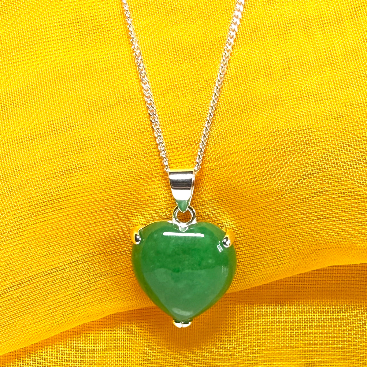 A stunning real green jade pendant heart shaped sterling silver, a traditional design necklace