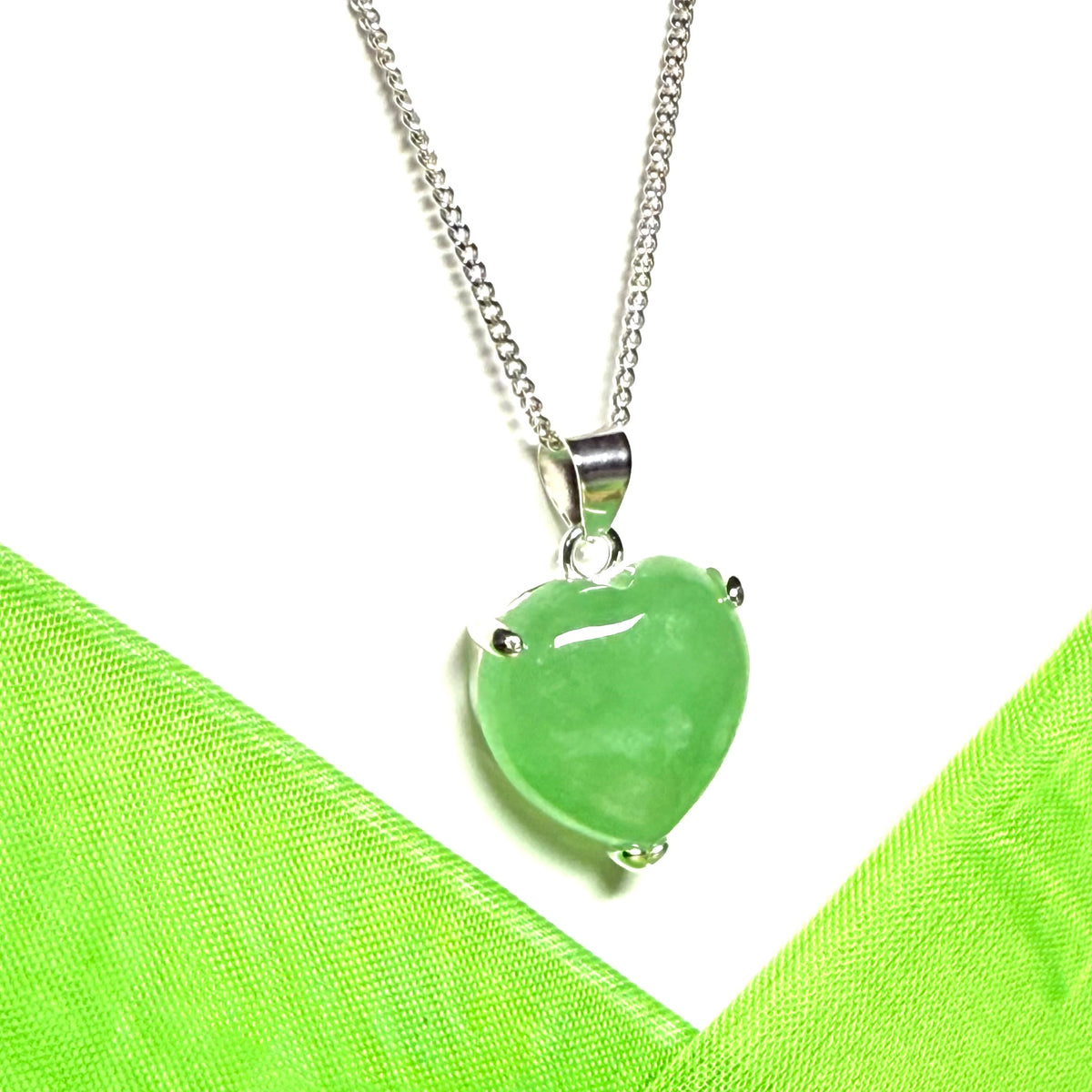 A stunning real light green jade necklace heart shaped sterling silver pendant