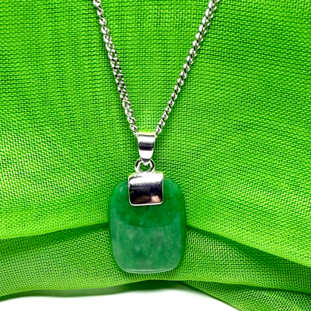 A stunning sterling silver cushion shaped real green jade necklace pendant with a solid curb chain included