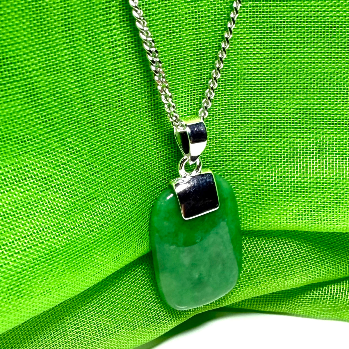 A stunning sterling silver cushion shaped real green jade necklace pendant with a solid curb chain included