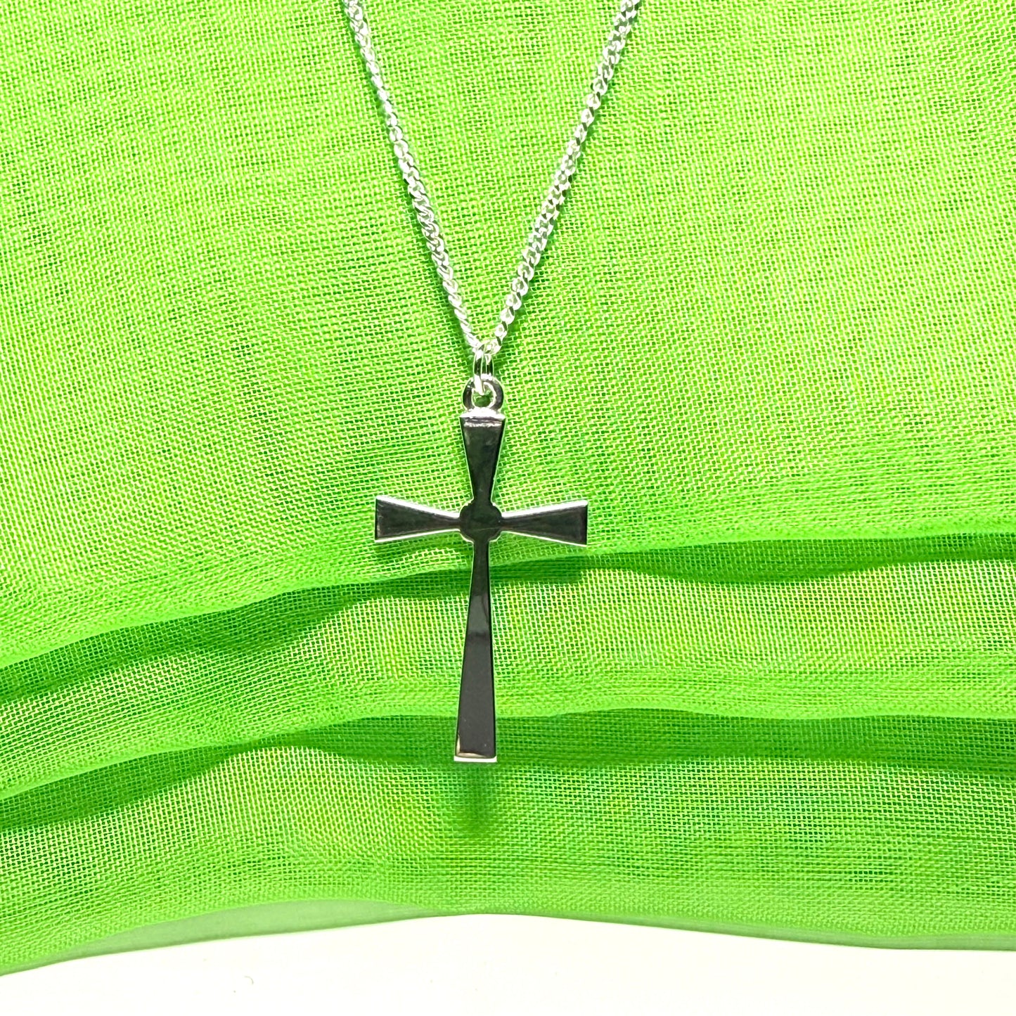 A thick solid sterling silver cross necklace fancy shaped pendant with a chain