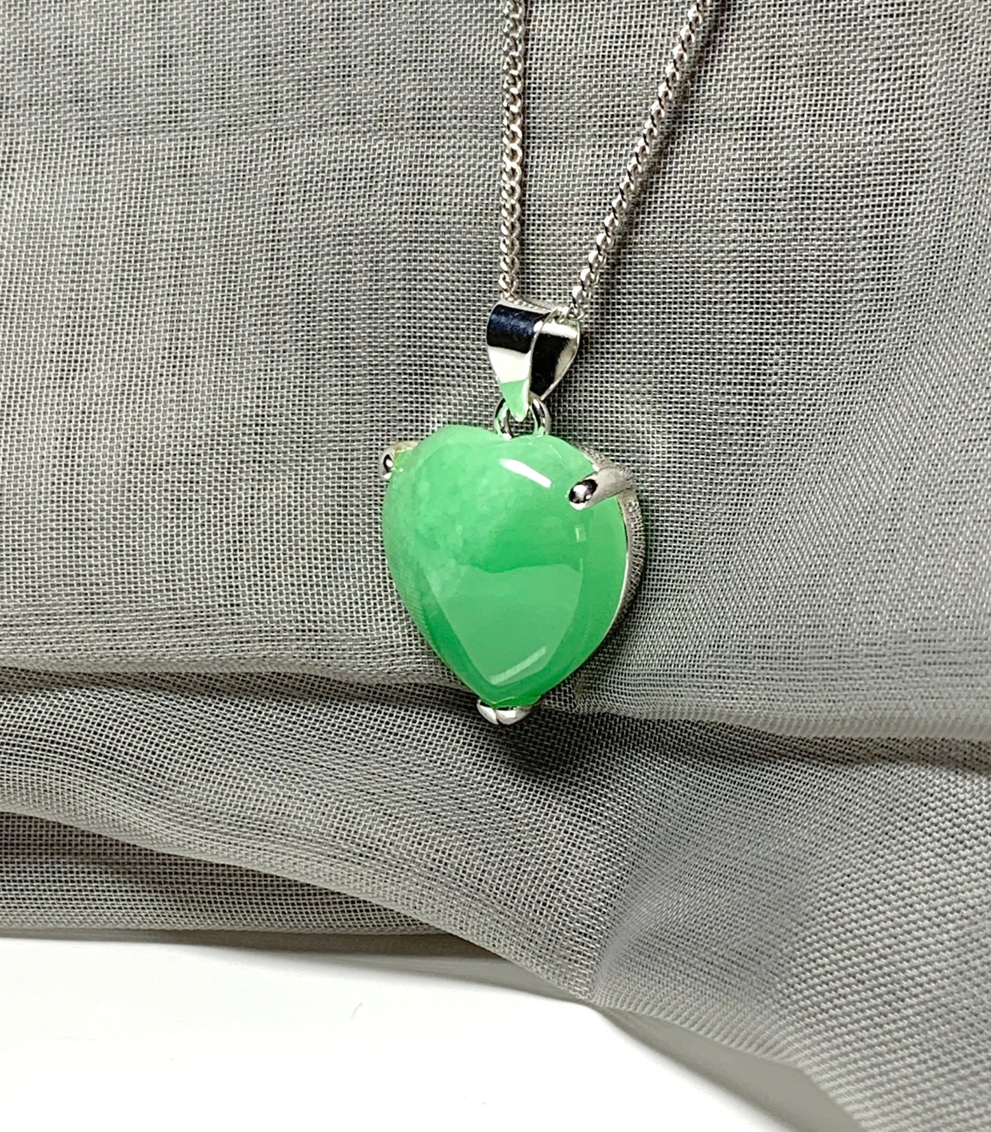 A beautiful and stunning real green jade necklace heart shaped sterling silver pendant