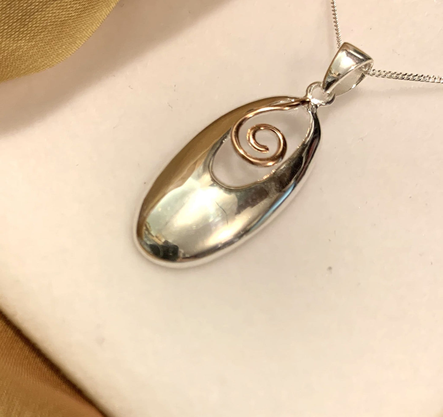 An Oval Two Tone Sterling Silver And Rose Gilt Necklace Pendant