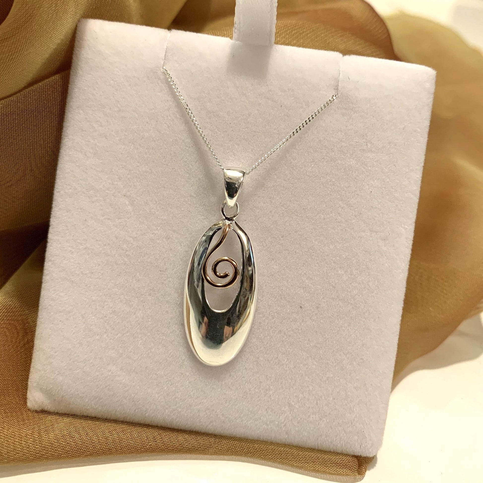 An Oval Two Tone Sterling Silver And Rose Gilt Necklace Pendant