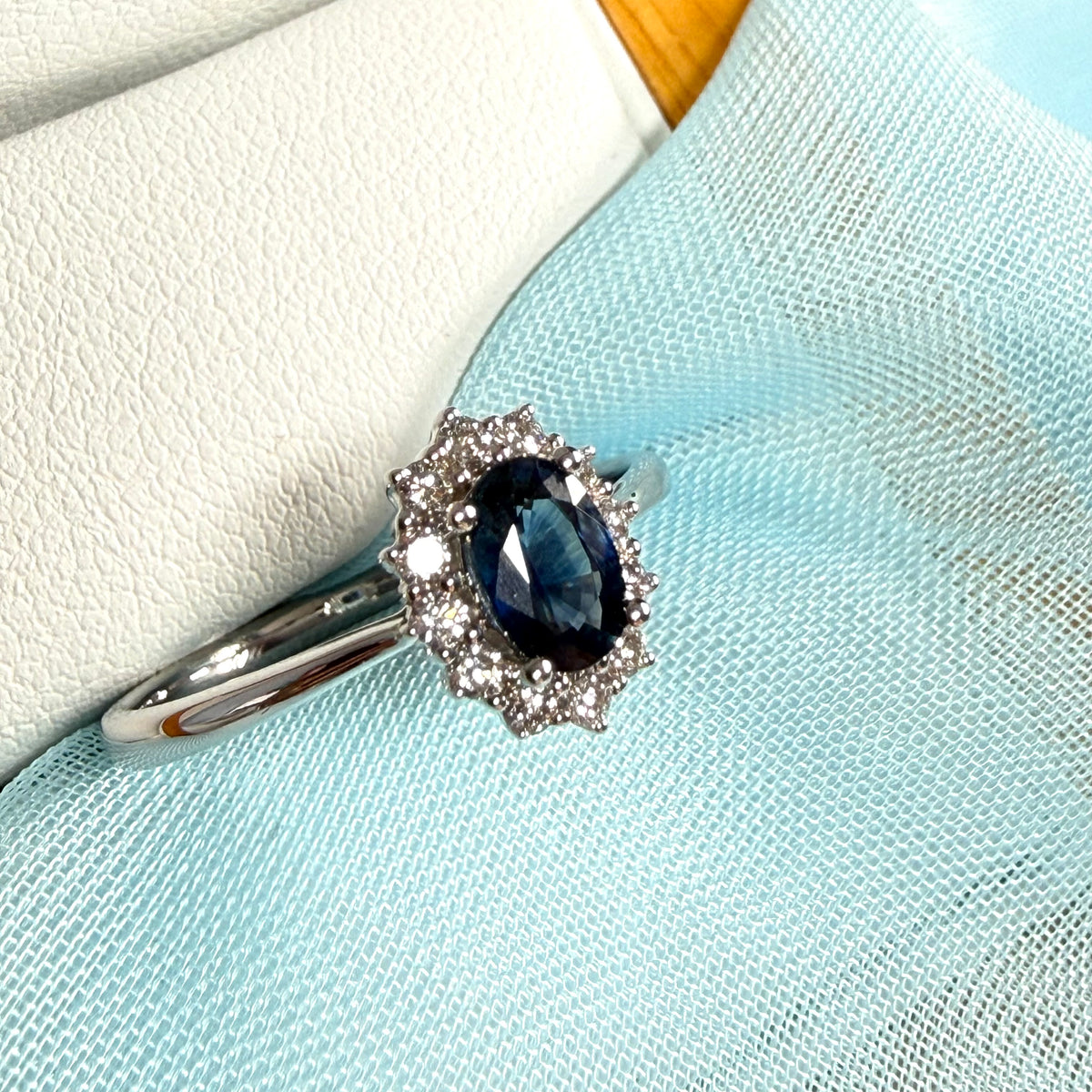 An oval Blue Real Sapphire and Diamond White Gold Cluster Ring