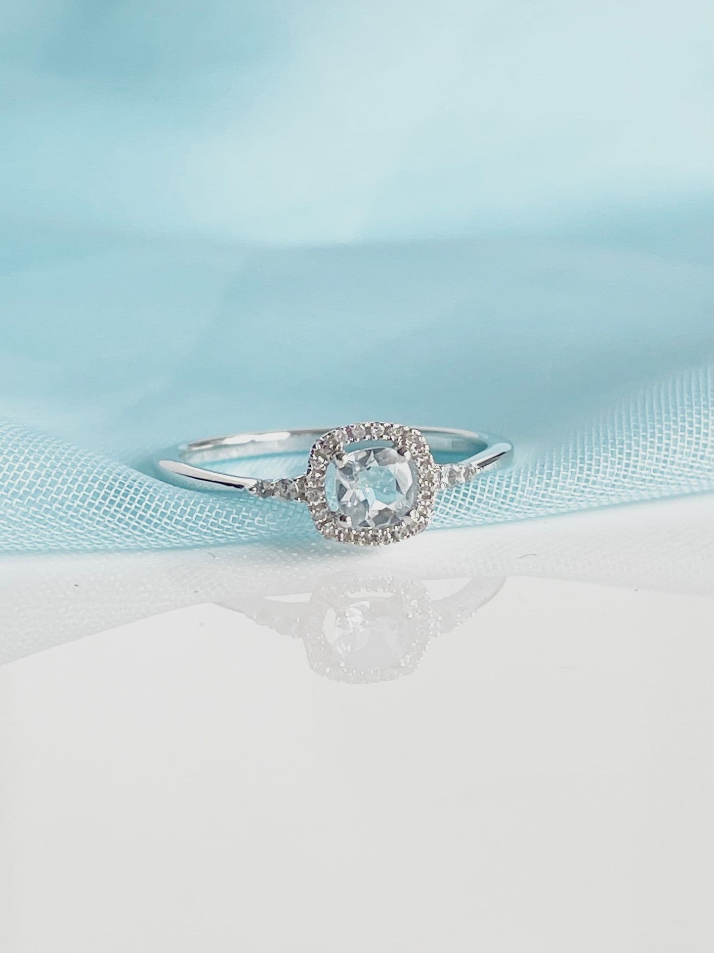 Real aquamarine ring and diamond white gold square cluster