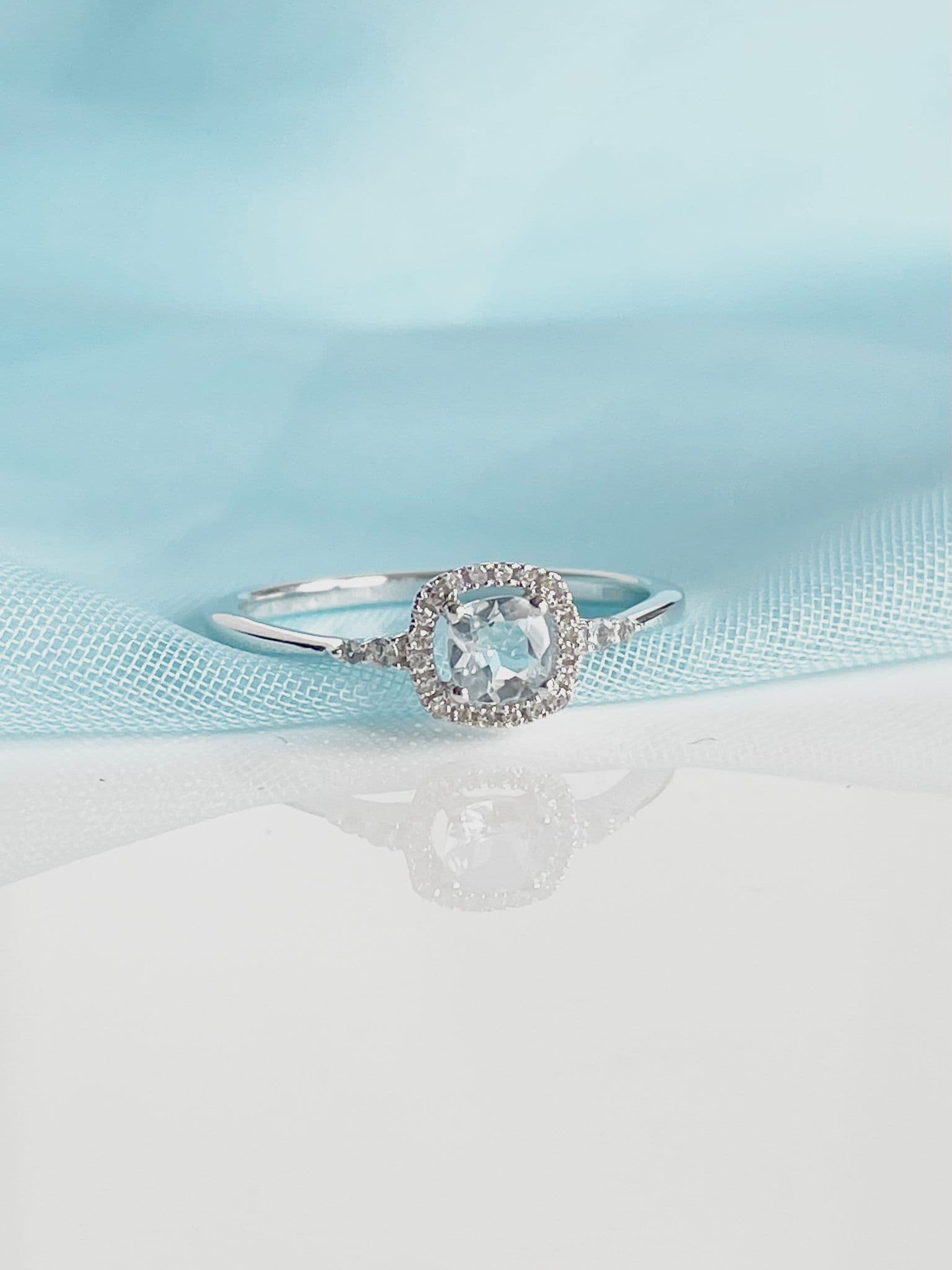 Real aquamarine ring and diamond white gold square cluster