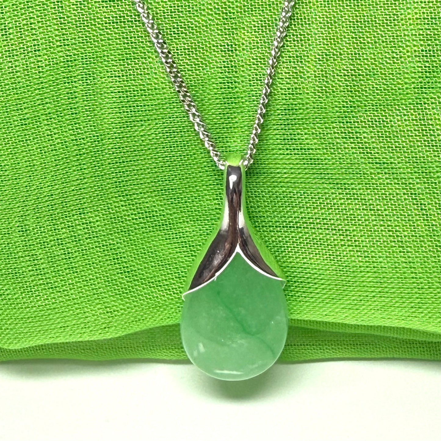 A beautiful real green jade necklace teardrop with a pear shaped pendant, a distinctive design