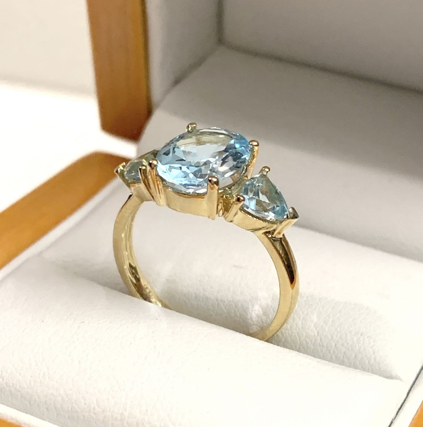 Blue topaz trilogy dress ring yellow gold