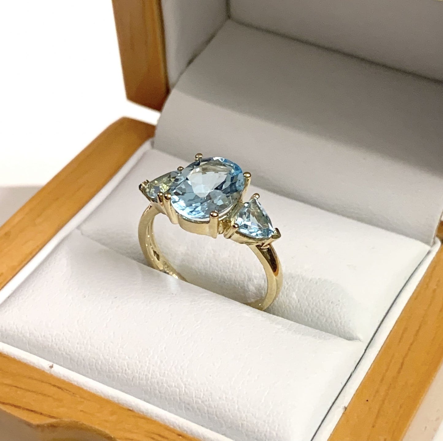 Blue topaz trilogy dress ring yellow gold