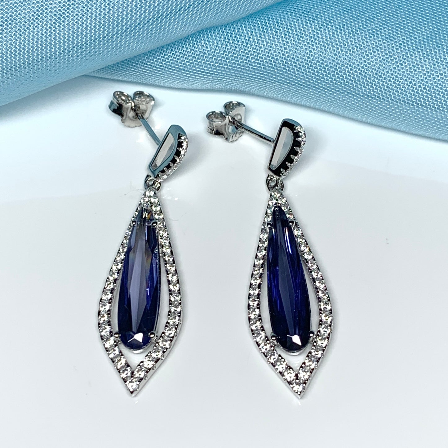 Blue pear shaped cubic zirconia silver cluster long drop earrings