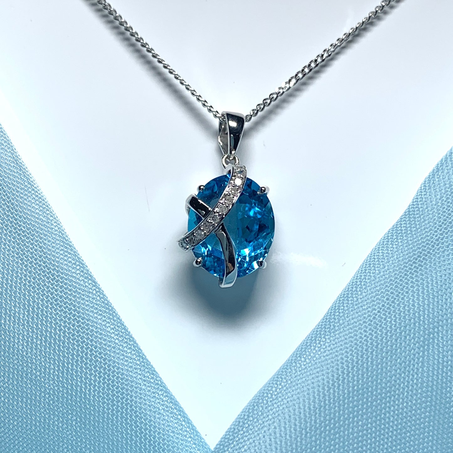 Blue topaz and diamond necklace white gold fancy oval shaped pendant