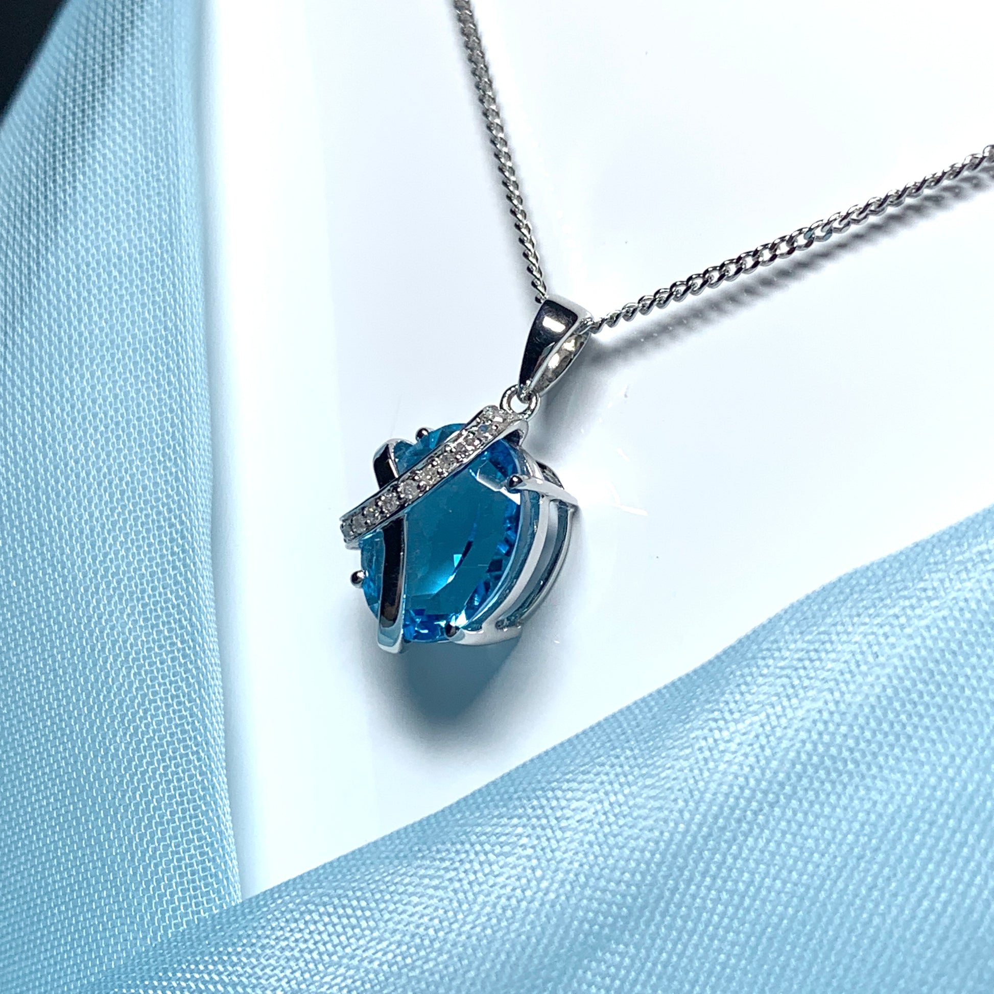 Blue topaz and diamond necklace white gold fancy oval shaped pendant