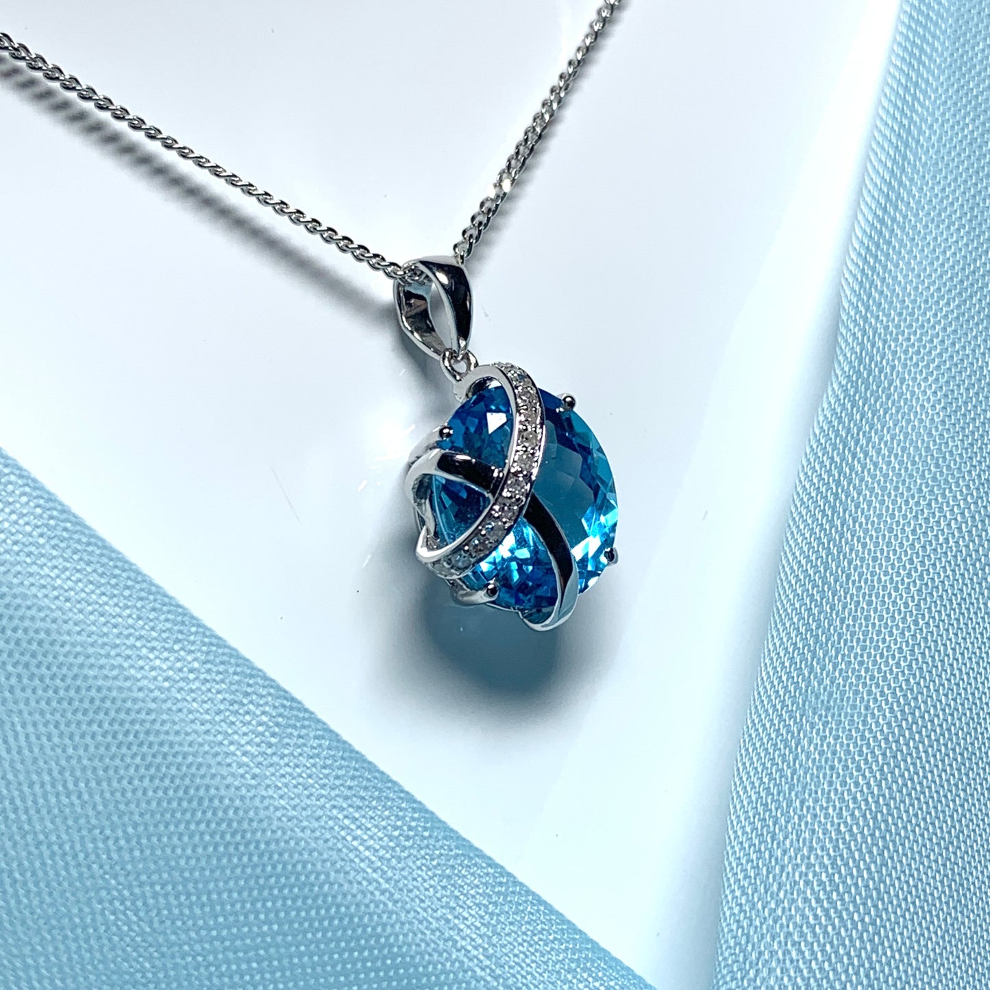 Blue topaz and diamond necklace white gold fancy oval shaped pendant