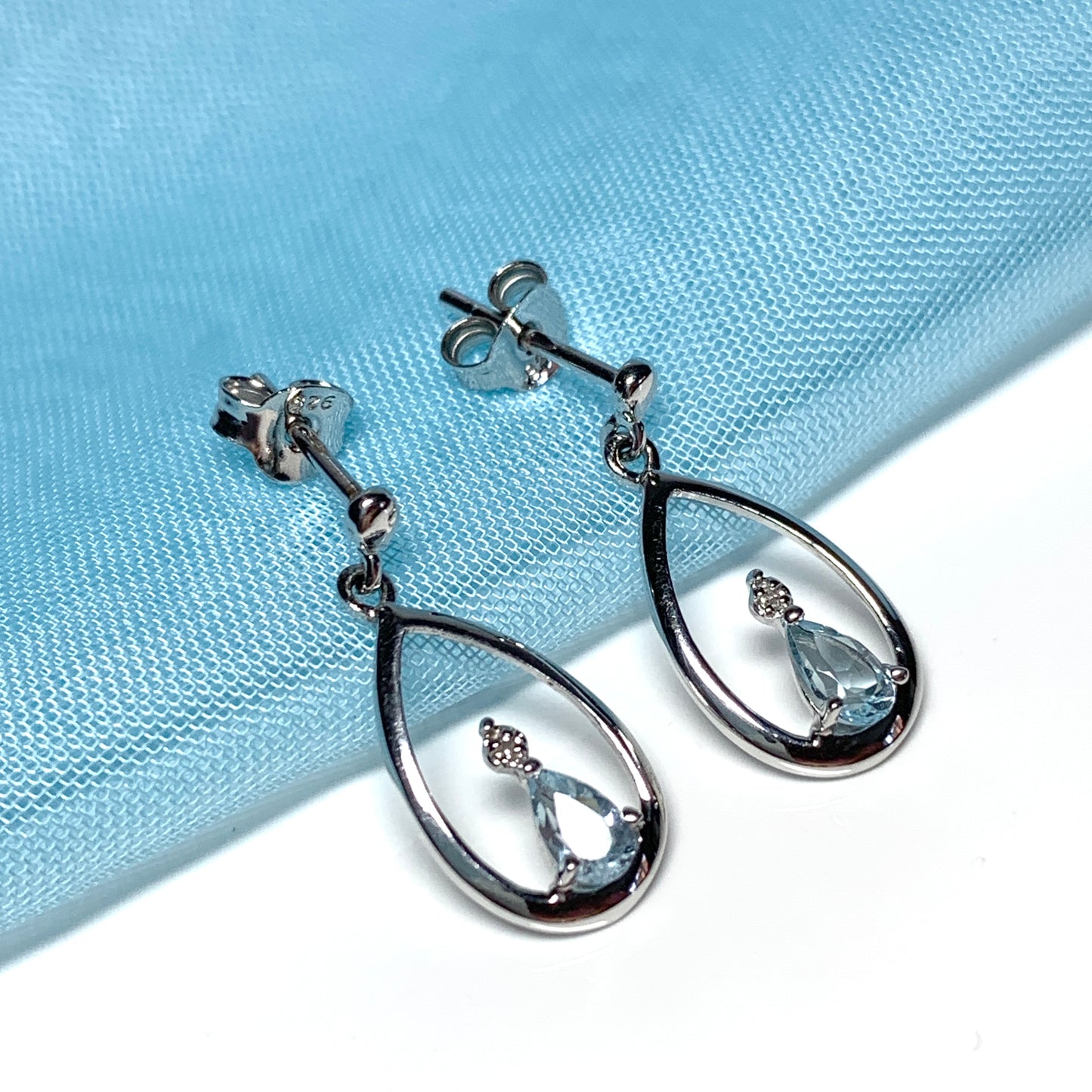 Blue topaz pear shaped sterling silver diamond set drop earrings