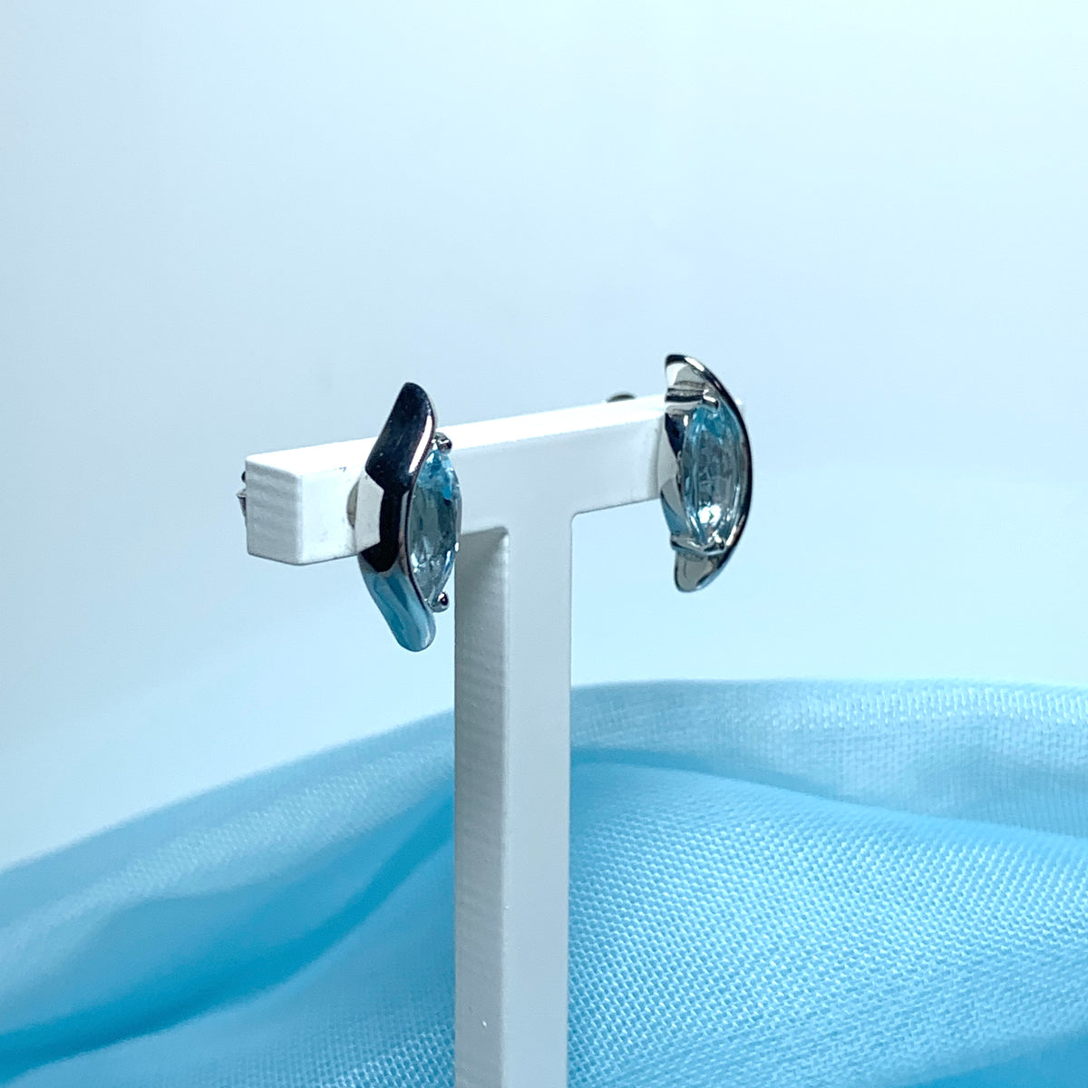 Blue topaz white gold marquise shaped fancy swirl stud earrings