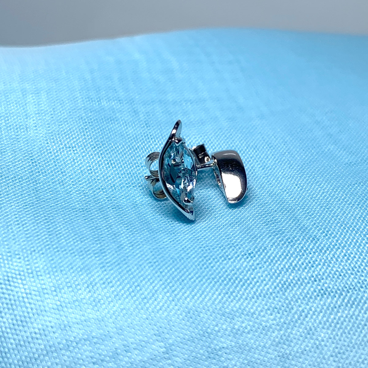 Blue topaz white gold marquise shaped fancy swirl stud earrings