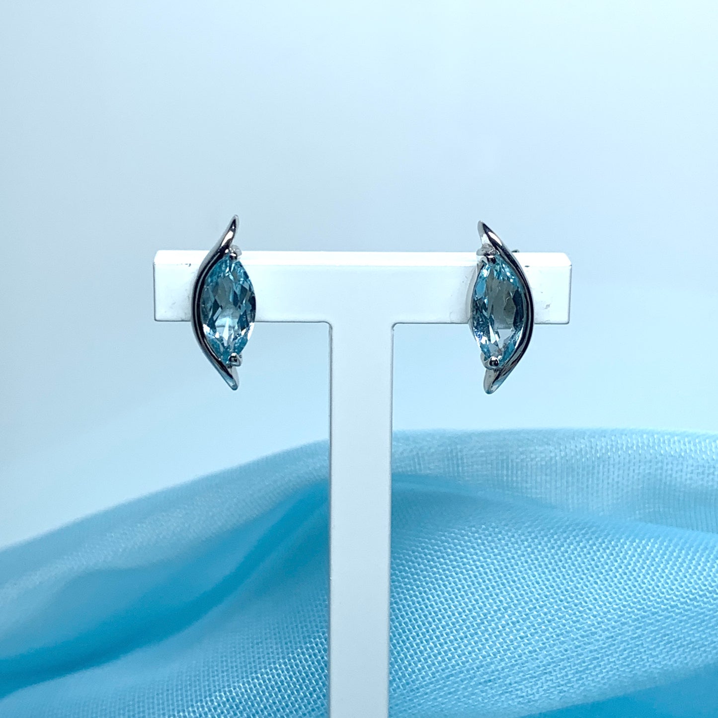 Blue topaz white gold marquise shaped fancy swirl stud earrings