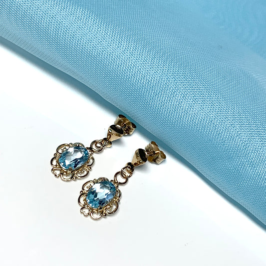 Blue topaz yellow gold oval shaped fancy scrolled drop earrings