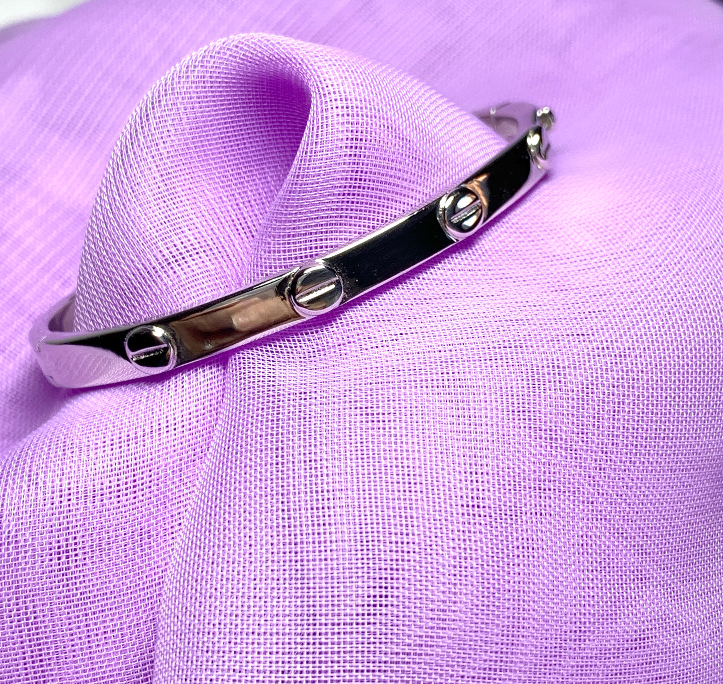 Child’s oval bangle screw head design patterned sterling silver