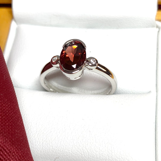 Oval garnet and cubic zirconia sterling silver ring