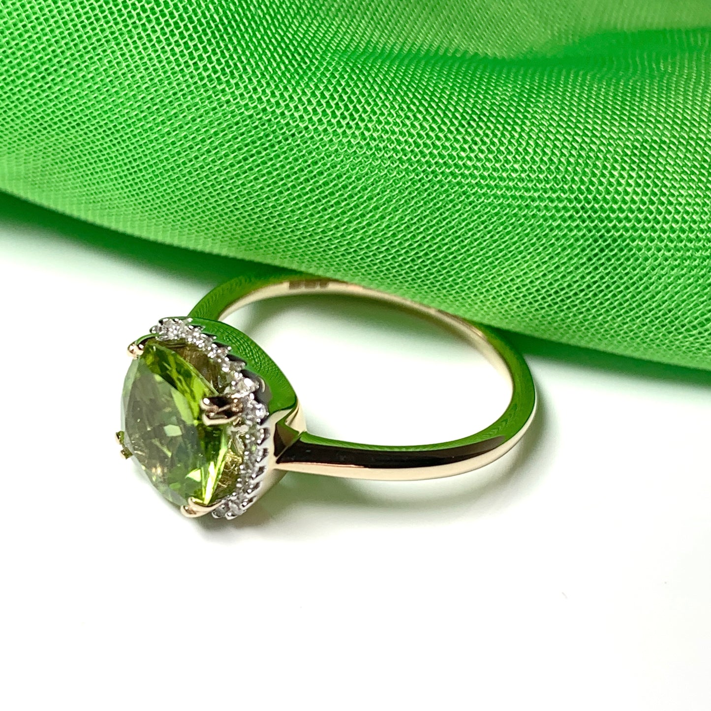 Cushion shaped yellow gold green peridot and diamond cluster ring