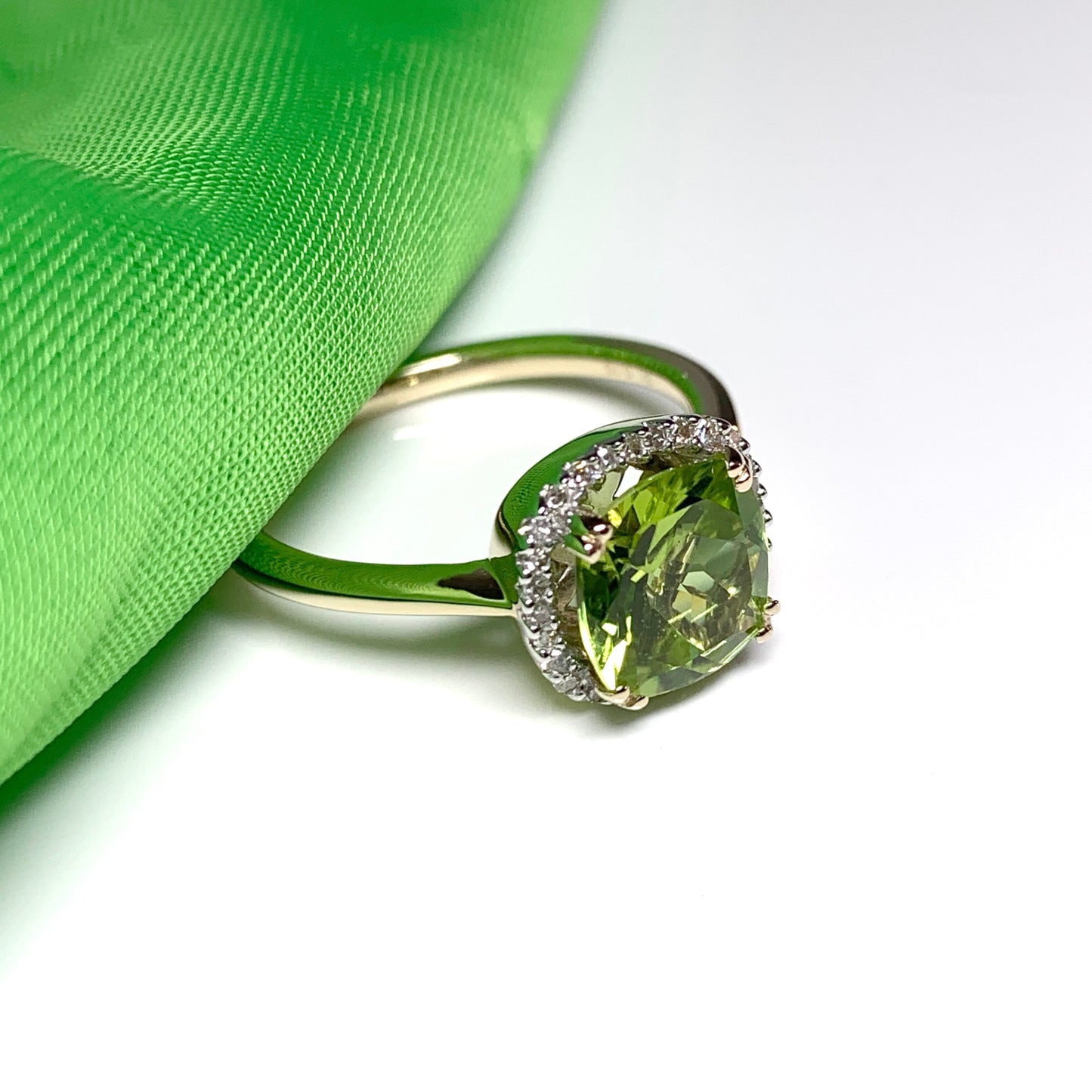 Cushion shaped yellow gold green peridot and diamond cluster ring