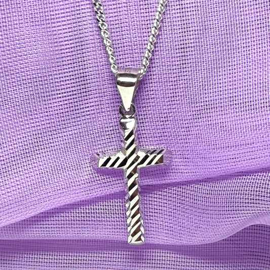 Diamond cut cross patterned sterling silver with a chain Included