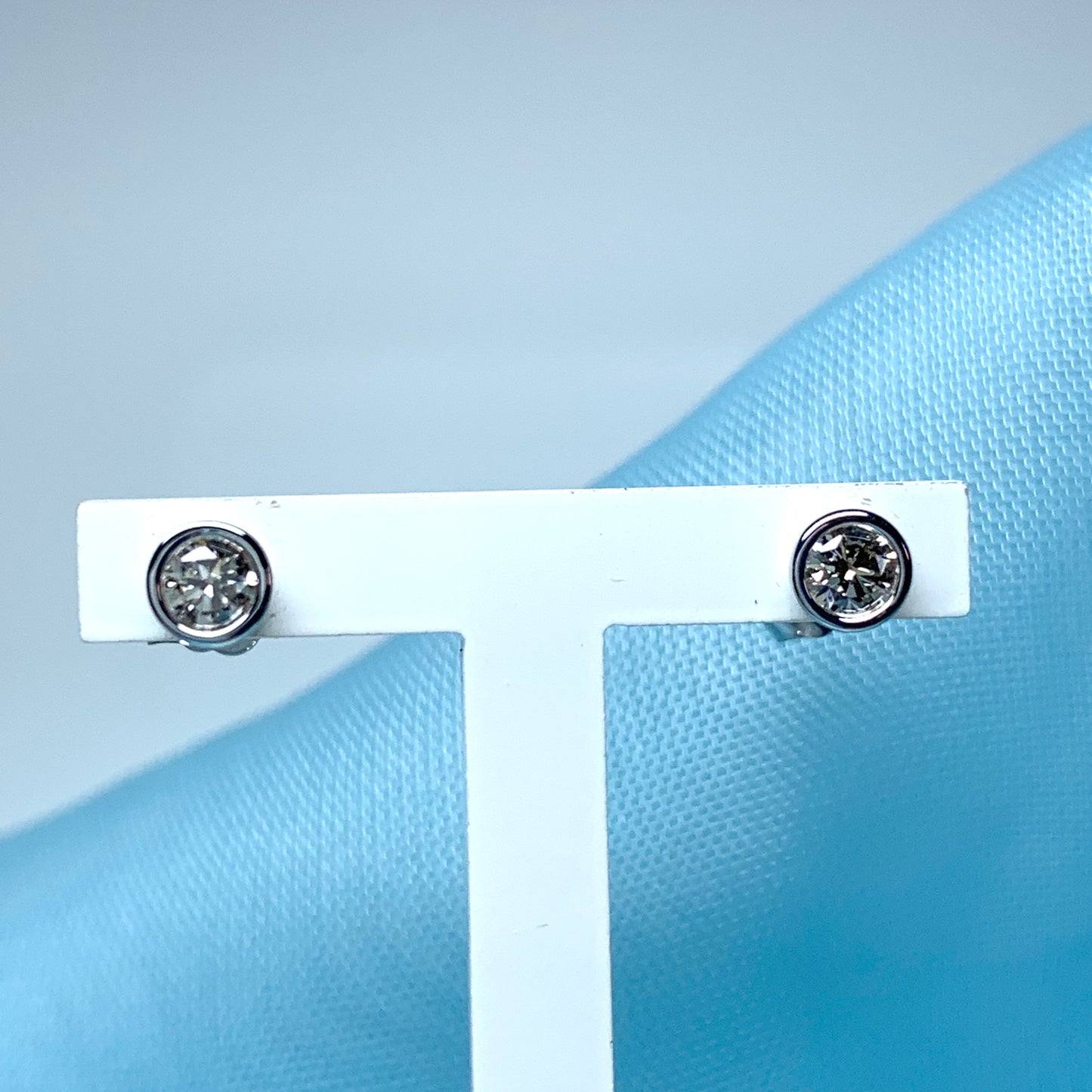 Diamond stud earrings rubbed over single stone smooth setting 25 Points