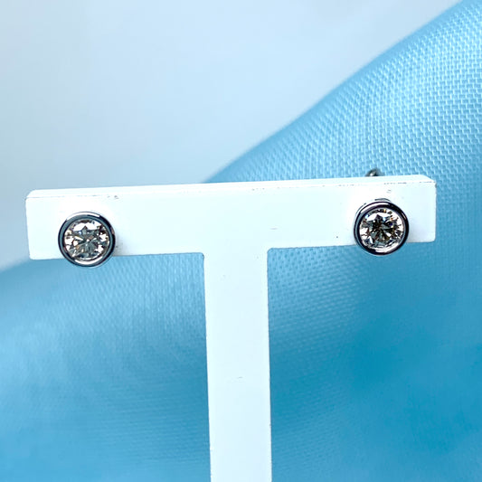 Diamond stud earrings rubbed over single stone smooth setting 25 Points