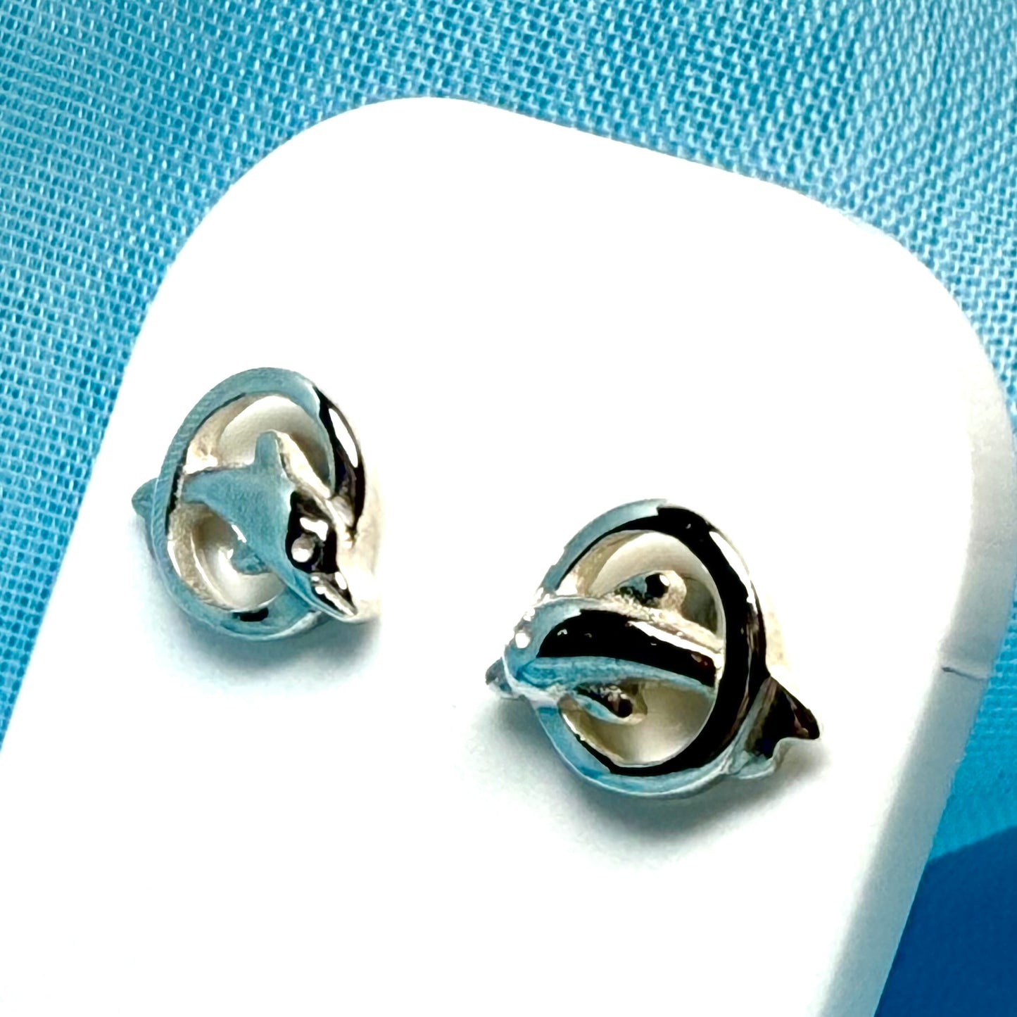 Dolphin stud earrings jumping through a circle sterling silver round