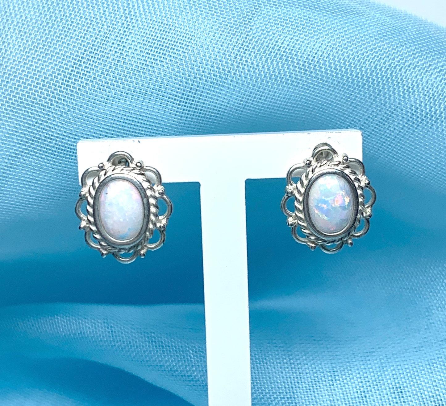 Fancy oval sterling silver opal stud earrings