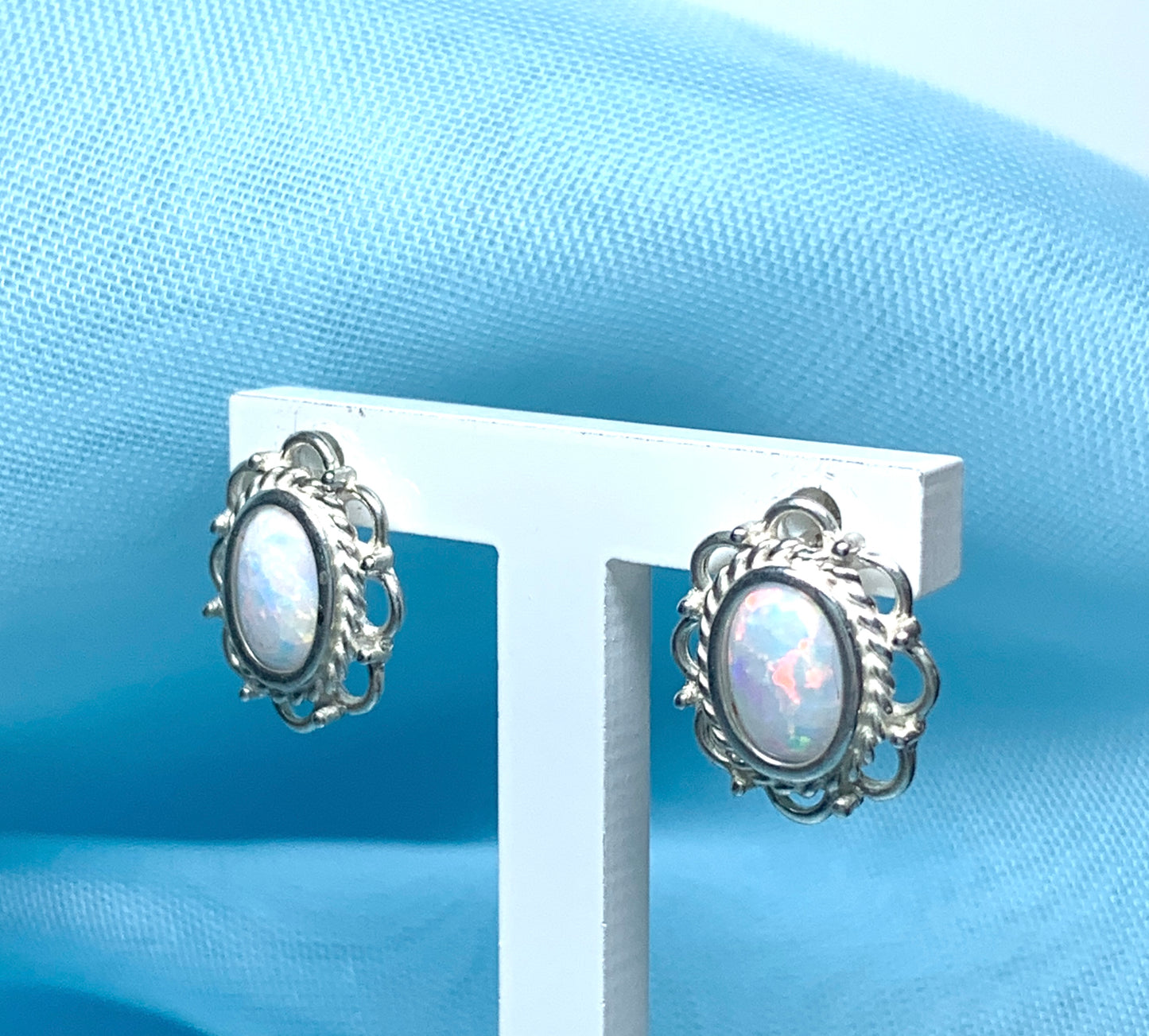 Fancy oval sterling silver opal stud earrings