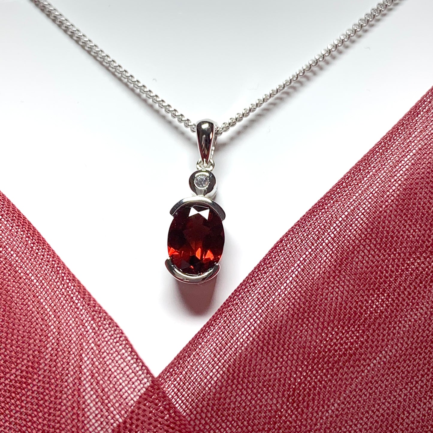 Oval garnet and cubic zirconia sterling silver necklace