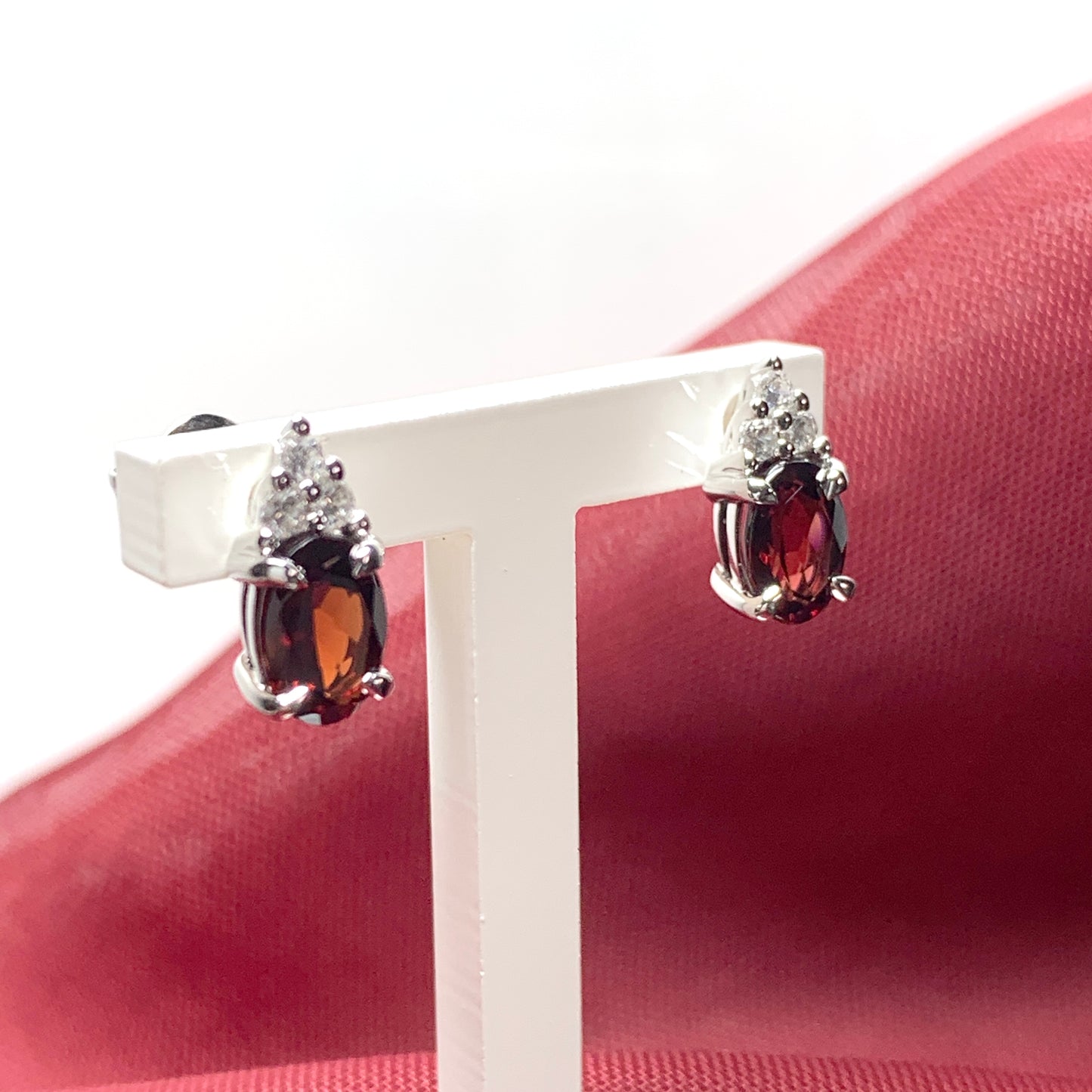 Garnet and cubic zirconia sterling silver oval earrings