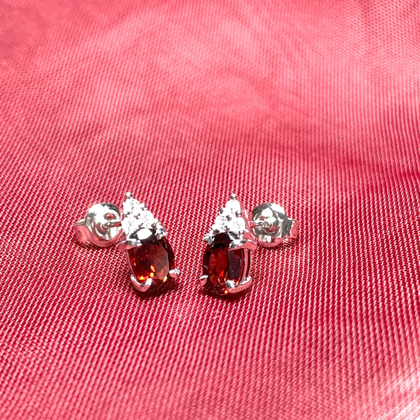 Garnet and cubic zirconia sterling silver oval earrings