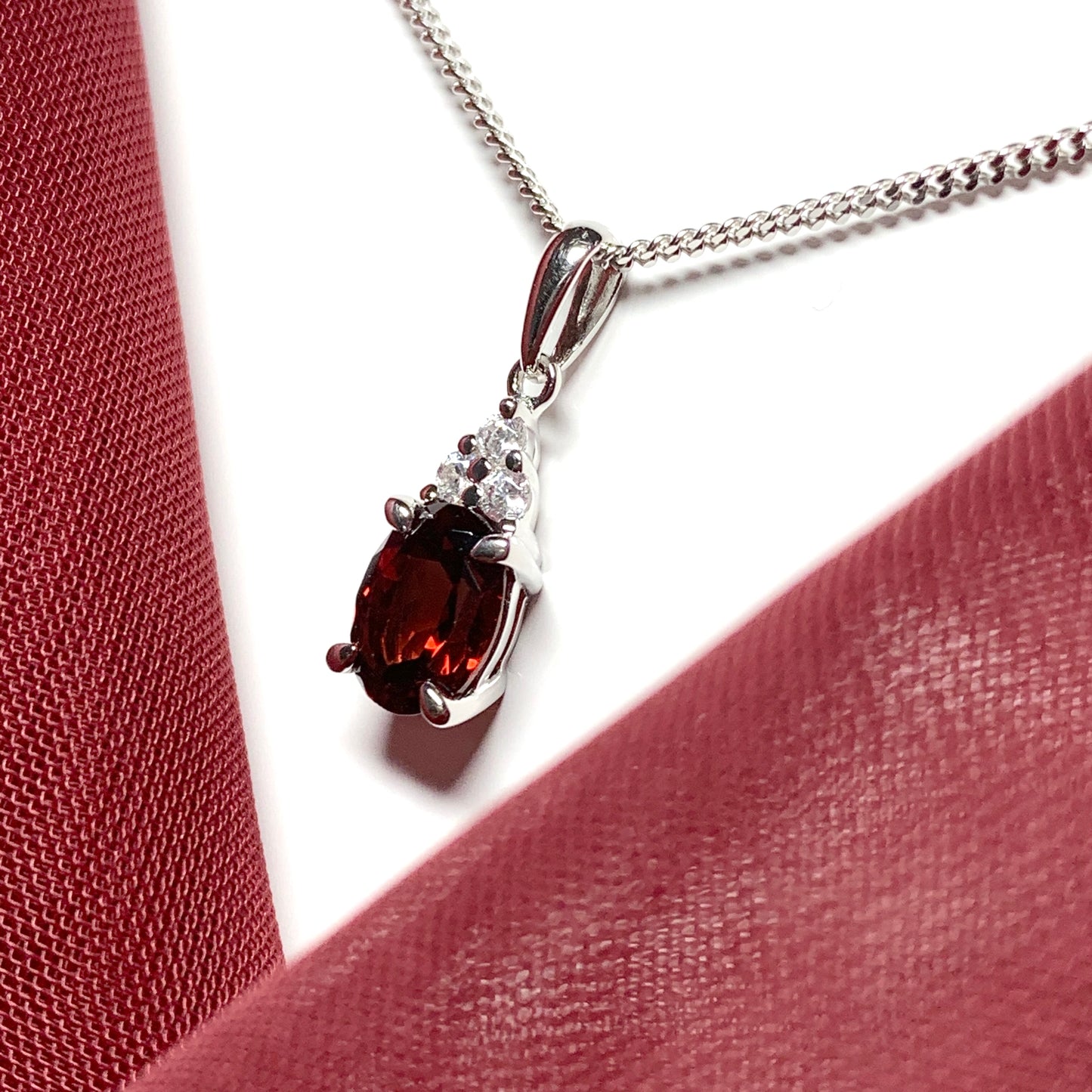 Garnet and cubic zirconia sterling silver oval necklace