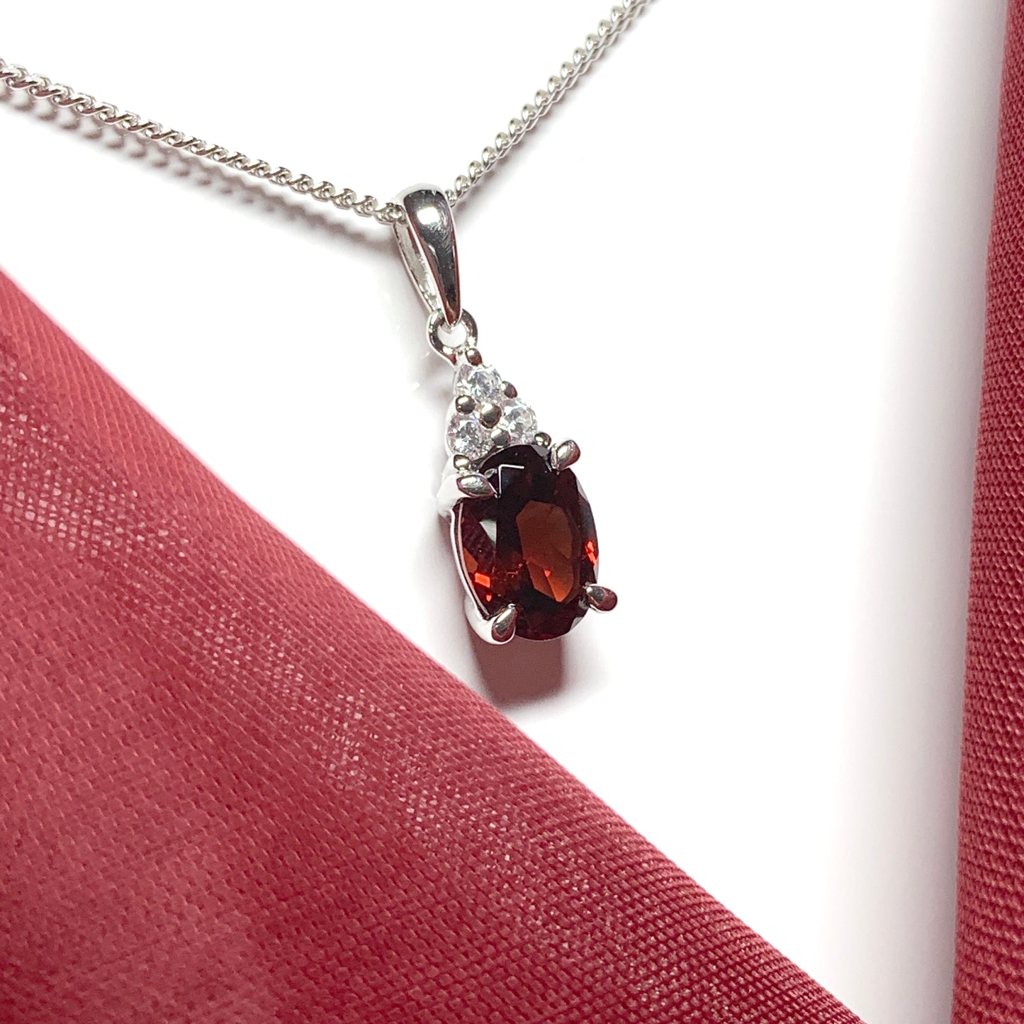 Garnet and cubic zirconia sterling silver oval necklace