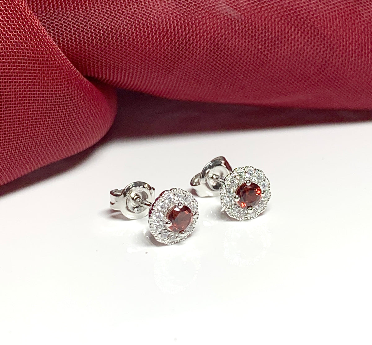 Garnet and cubic zirconia sterling silver round cluster stud earrings