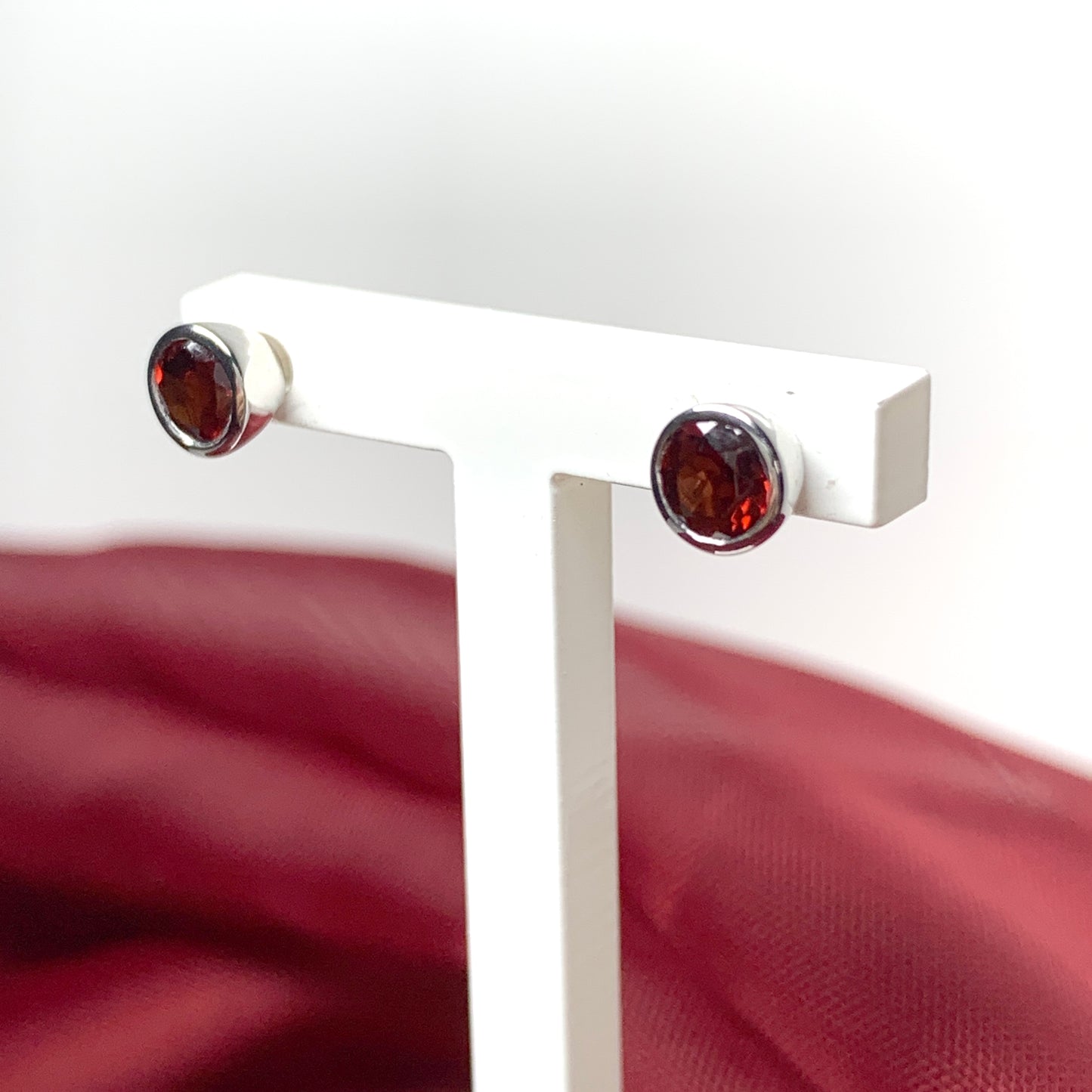 Garnet silver round stud earrings smooth rubbed over setting