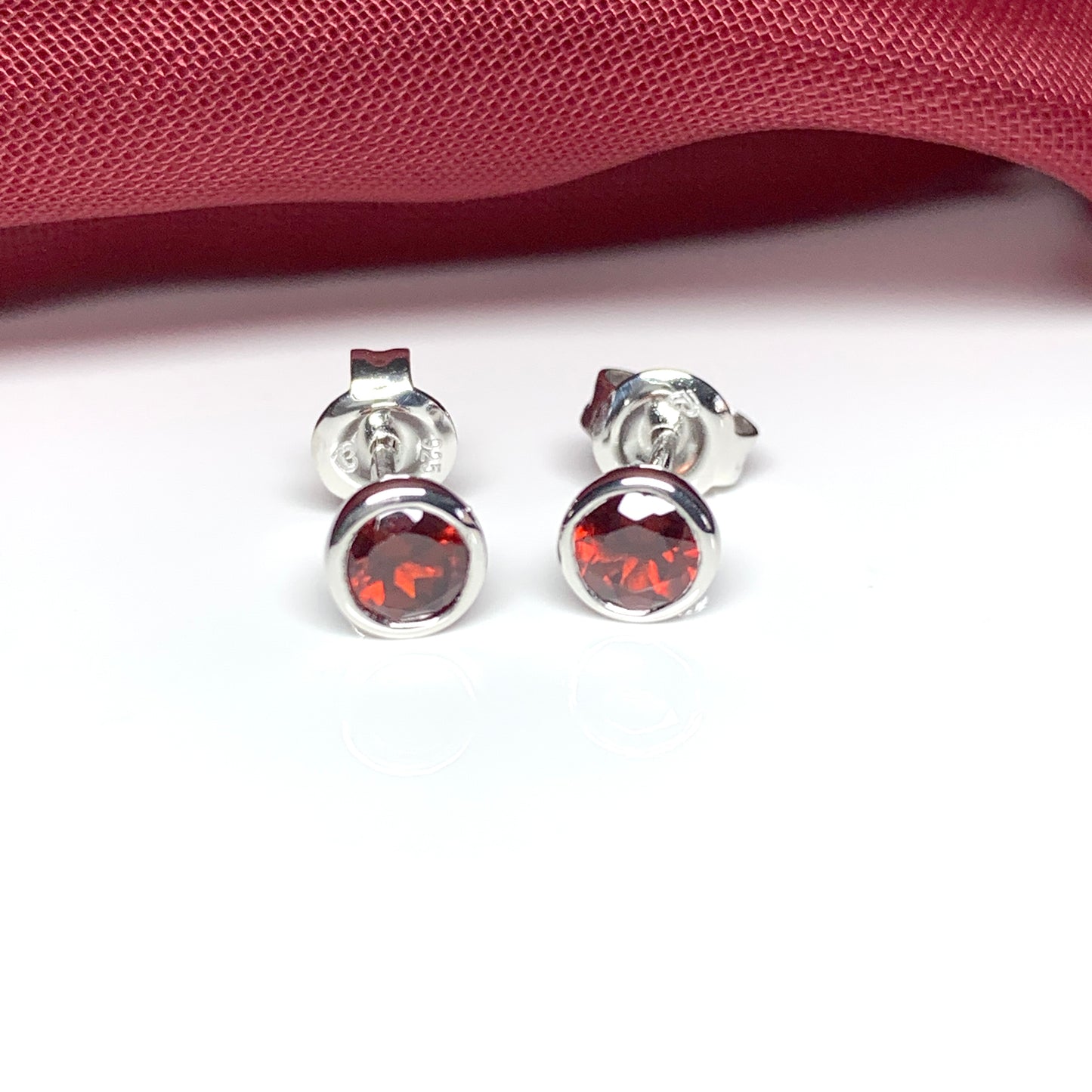 Garnet silver round stud earrings smooth rubbed over setting