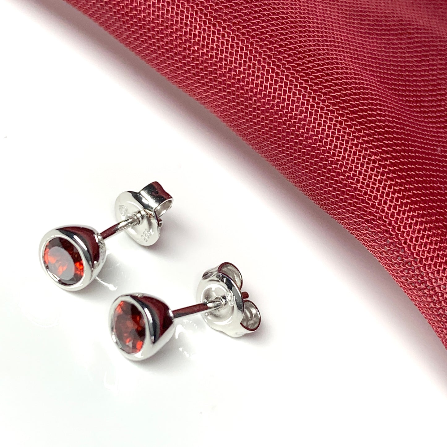 Garnet silver round stud earrings smooth rubbed over setting